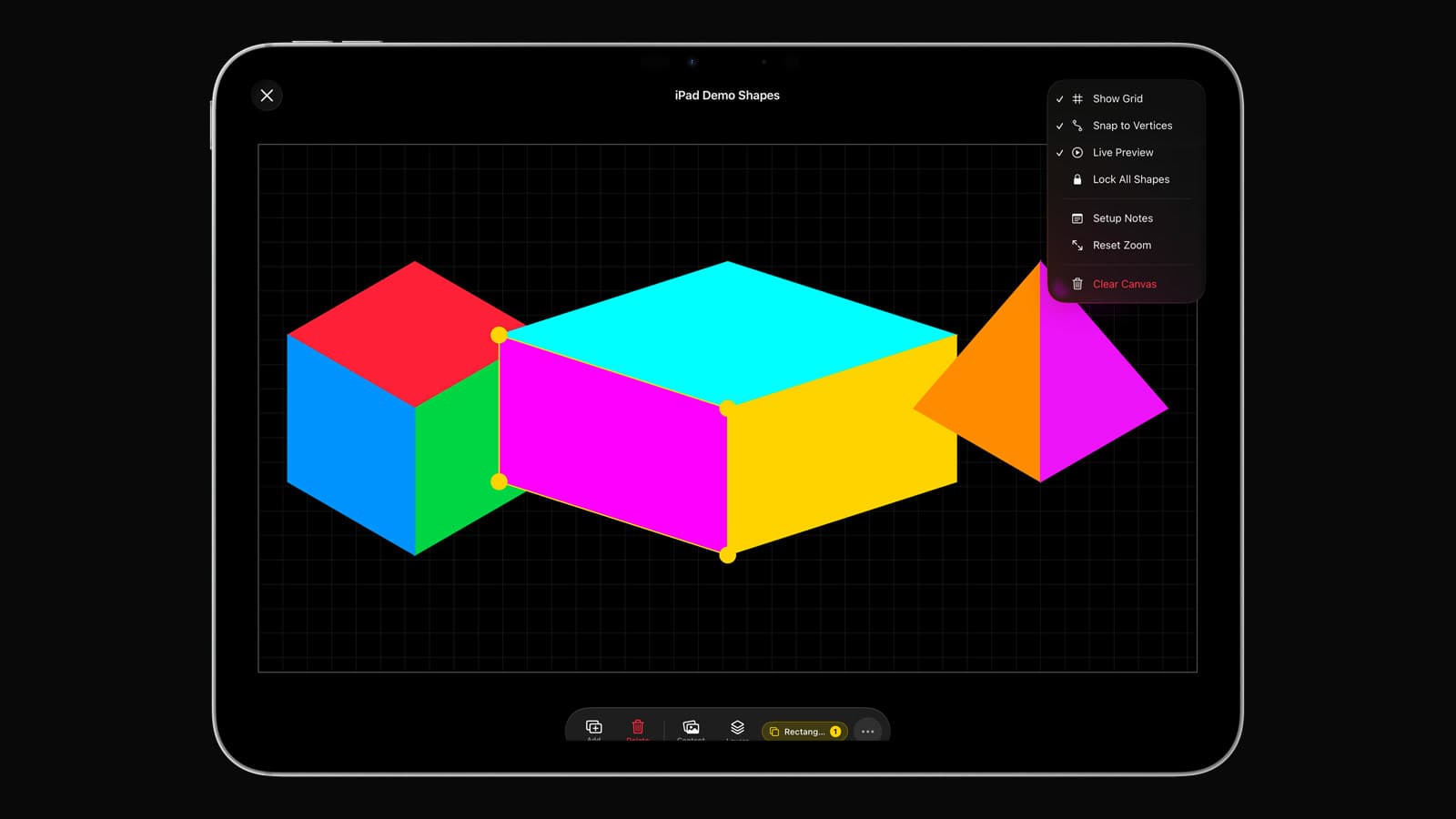 The Visomapper mapping canvas on an iPad with several colored surfaces aligned to a grid